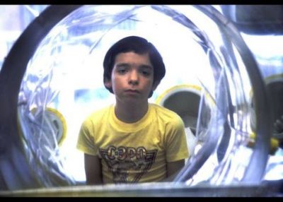 David Vetter (September 21, 1971 – February 22, 1984)This kid’s story haunts me.If you’ve never heard of him, David Vetter was born with a severe immune defficiency which forced him to live in a plastic “bubble” for his entire life.His situation has been turned into a joke, both on Seinfeld, and in the movie Bubble Boy, but the true story is anything but funny.From birth until the day before he died, he never felt the touch of another human.  Imagine what it would be like to have never had your mother or father or grandparent ever give you a comforting touch as a young child.  Imagine the isolation he must’ve felt.  He had nightmares of what he called the “King of Germs”, which to me is absolutely terrifying.The really sad thing is that his team of doctors knew before he was concieved, that there would be a chance he would turn out the way he did, and encouraged his mother to have another child regardless.  There is evidence that suggests that they did so in order to use David as a science experiment.  Definitely creepy that science would toy with a child in that way.  In the end his doctors abandoned him as they used their research on him to get promotions and further their careers, moving far away.This image, of this sad kid looking out of his bubble, on a world he would never experience, is really impactful to me, sad and intriguing.If you want to learn more, click the follow through for the wiki article, or check out the PBS “Boy in the Bubble” documentary which you can get via netflix.
