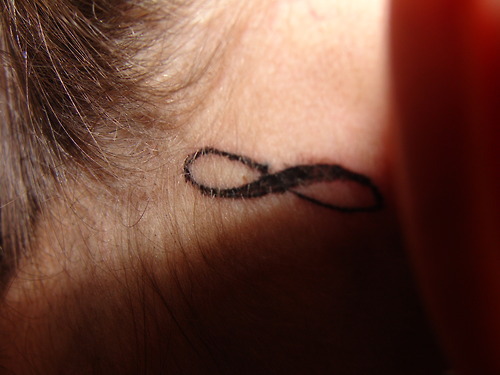 Her first tattoo, age 15. Behind her ear. She hates it. And regrets it.
