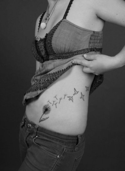 Dandelion Tattoo by dandelion seeds transforming to birds signifying escape.