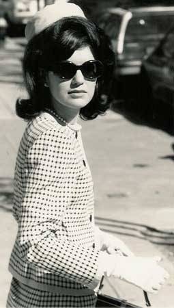 Jackie O in her signature pillbox hat and over-sized frames sunglasses.