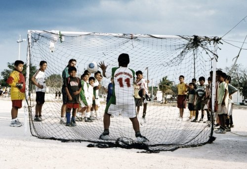 Children playing soccer in the ancient Mayan city of Tulum, Mexico.