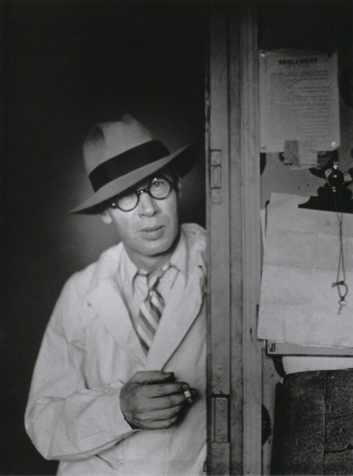 Brassaï Henry Miller au chapeau dans l’embrasure de la porte  [Henry Miller Standing in a Doorway Wearing a Hat] Hôtel des Terrasses, Paris, circa 1931-1932 From Brassaï, Paris