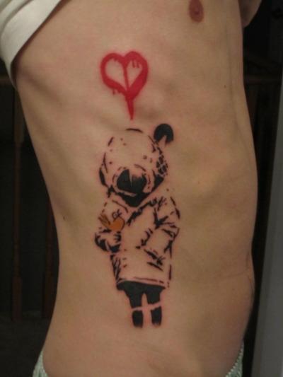 This is my brother’s Banksy tattoo. (I showed him Bansky’s art a couple of years ago). We both fell in love with the art, but he’s the one brave enough to get the tattoo.  My brother and I are both fascinated  with apocalyptic themes, and this is a nice homage to that fascination. 