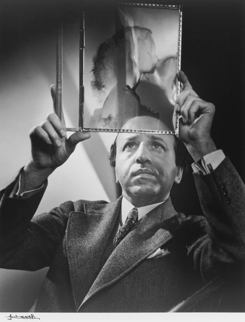 Yousuf Karsh SelfPortrait 1946 examining the negative of the actress Peggy