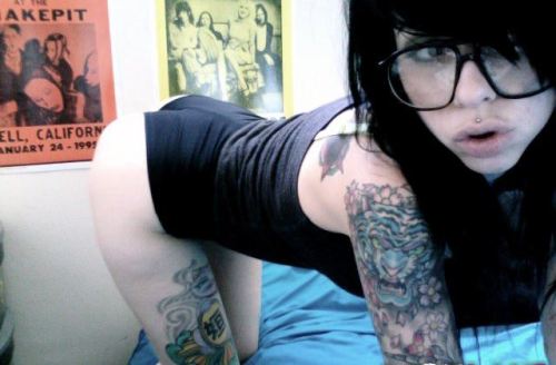 There is something about a woman with tattoos and glasses