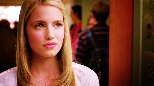 Quinn Fabray was sitting in the middle of the football field surrounded by 
