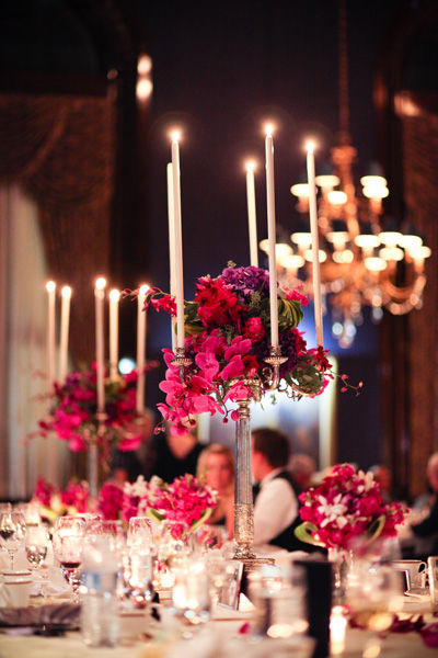 Red pink and purple table decor for a wedding reception