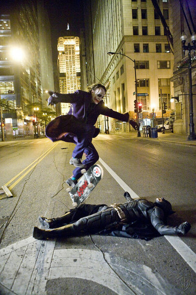 jamesydesign:  Heath Ledger as the Joker skate boarding over Christian Bale as Batman while they take a break on the set of The Dark Knight. Possibly the coolest thing ever?