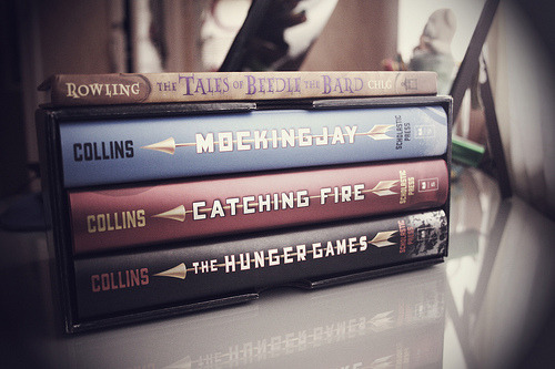 prettybooks:  (by -darkpantomime)  I want to read these. A copy of The Hunger Games trilogy can complete my vacation. :) But no, I’m as poor as a rat this summer because there’s no allowance. lol.