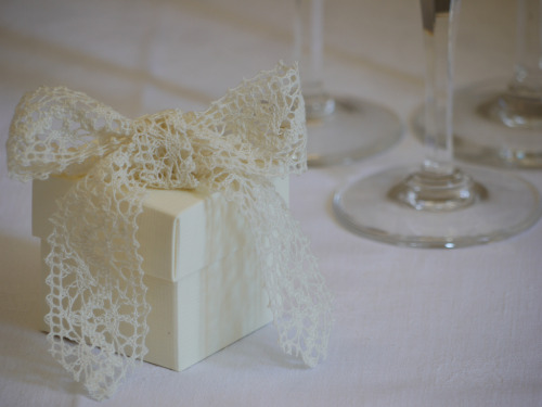 Positively gorgeous crochet lace bow wrapping an ivory favor box Highres