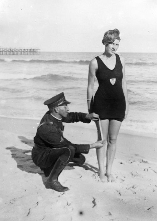 maudelynn:  “Smokey” Buchanan from the West Palm Beach police force, measuring the bathing suit of Betty Fringle on Palm Beach, to ensure that it conforms with regulations introduced by the beach censors. c.1925 