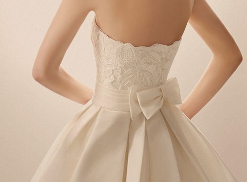 a wedding dress with a bow would probably be perfect lol a corset top with