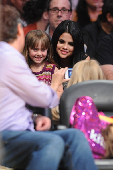  Selena Gomez with a fan at the Lakers game 