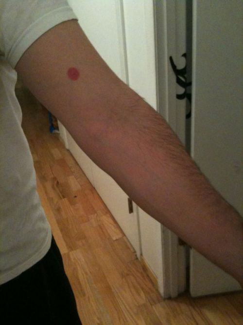 sheerhippo: aprettygoodstart: My other tattoo. Really. It’s not a rash or a hive or a swine flu shot gone wrong. It’s a fuchsia dot. Is there some sort of significance behind it? There sure is! Buckle up for a story. My Freshman year of high school (97-98), four guys were friends. Two of them had houses in Cape Cod, Mass. They decided that the four of them would go up to the Cape for vacation. Before the trip one of those guys (who is famous for telling nonsense stories) spun a yarn about a man dressed up in a fish costume at a gas station on Cape Cod washing windows. While he was riding past the fish man, the fish looked up, waved at him and said &#8220;Hello, Matt.&#8221; Matt responded in kind with &#8220;Hello, Fysh.&#8221; After that, the four friends begin greeting each other with &#8220;Hello, Fish!&#8221; Another of the four friends (who is famous for harebrained schemes) decided that the trip should become an annual one and that when they were all old enough to drive they would get old VW beatles in their favorite color. One picked red, another green, another yellow, and the last picked purple. These friends began referring to themselves as The Fysh. Fysh is spelled differently for no good reason at all and there is a dot over the y, like the German umlaut, also for no good reason. So as the group grew, more fysh were added, each with their own color. I transferred into my high school in Sophomore year. By that time all the normal colors were taken, so I consulted a box of crayons and chose fuchsia. Mostly because I like alliteration. (Fuchsia Fysh) Ten years later we&#8217;re all still very close friends, so about a year ago, a bunch of us who are now scattered all over the country decided to go and get dots (like the dot over the Y in fysh) with our color tattooed somewhere on our bodies. The End.