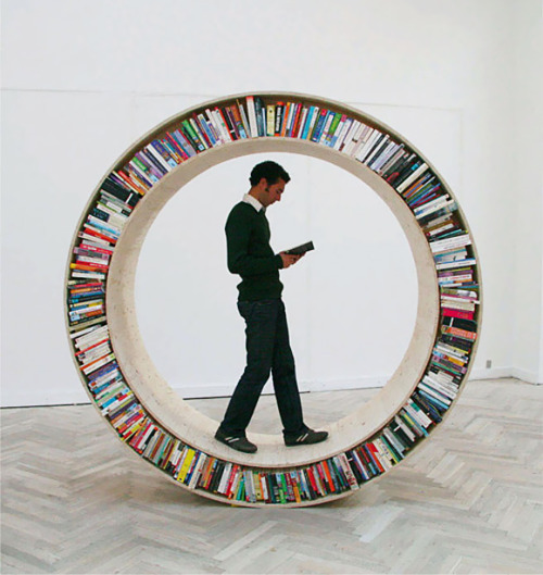 parenthesized: When I see this, all I can think is “…”. Maybe that’s the beauty of this bookcase; it’s thoroughly perplexing and full of possibility. Thanks, David Garcia, for making a bookcase/ literary hamster wheel/ ring for a colorful escape during a rainy day? cheers, amber